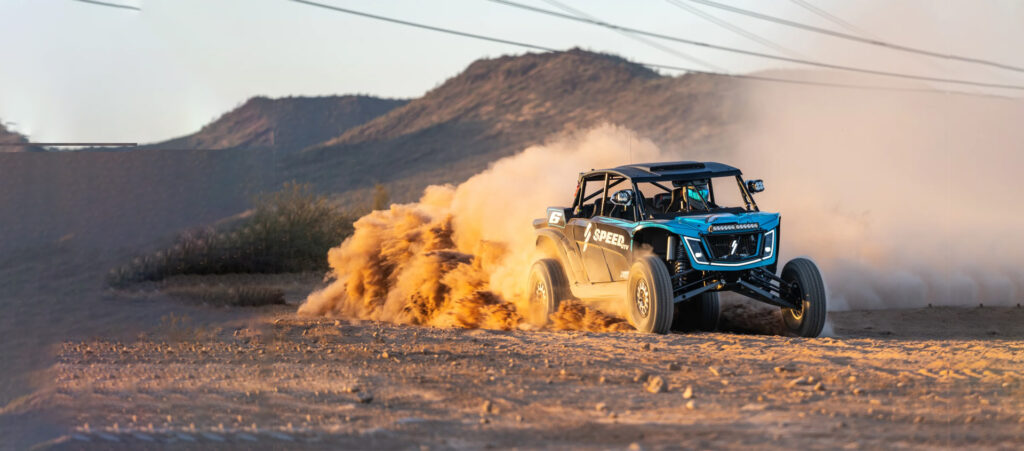 "ATV equipped with off-road tyres riding through UAE desert dunes